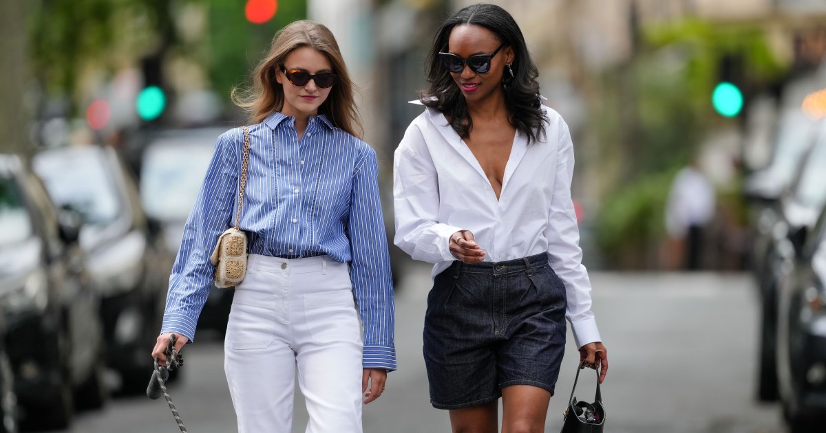 PARIS, FRANCE - MAY 20: Segolene Hyppolite (L) wears sunglasses, a blue and white oversized shirt from Tommy Hilfiger, a raffia beige bag from Vanessa Bruno, high waist white denim pants from Vanessa Bruno ; Emilie Joseph (R) wears a summer wardrobe capsule: an oversized white poplin button-down shirt from Figaret Paris , tucked into high-waisted denim bermuda/ jorts / denim shorts, classic / basic / timeless accessories such as black sunglasses from the Korean fashion brand Gentle Monster, a small black top handle leather handbag, during a street style fashion photo session, on May 20, 2024 in Paris, France. (Photo by Edward Berthelot/Getty Images)